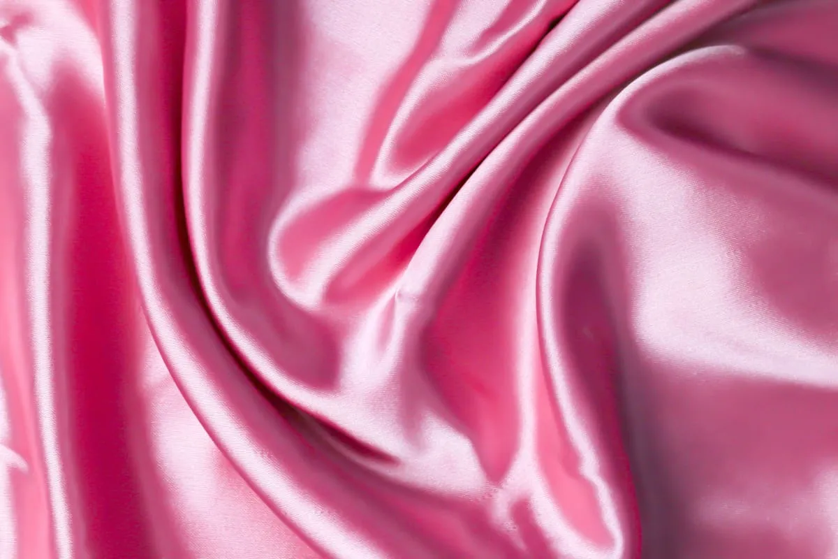 Pink satin fabric with soft highlights