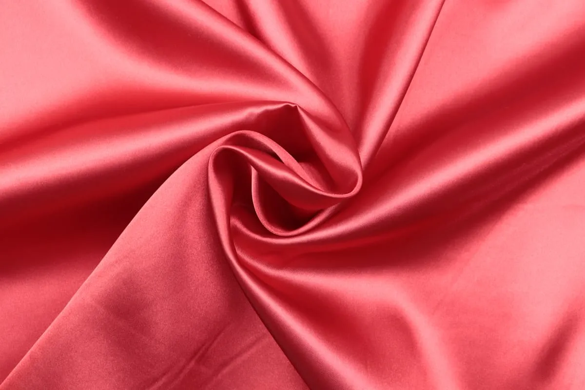 Rose satin fabric gathered into an elegant swirl