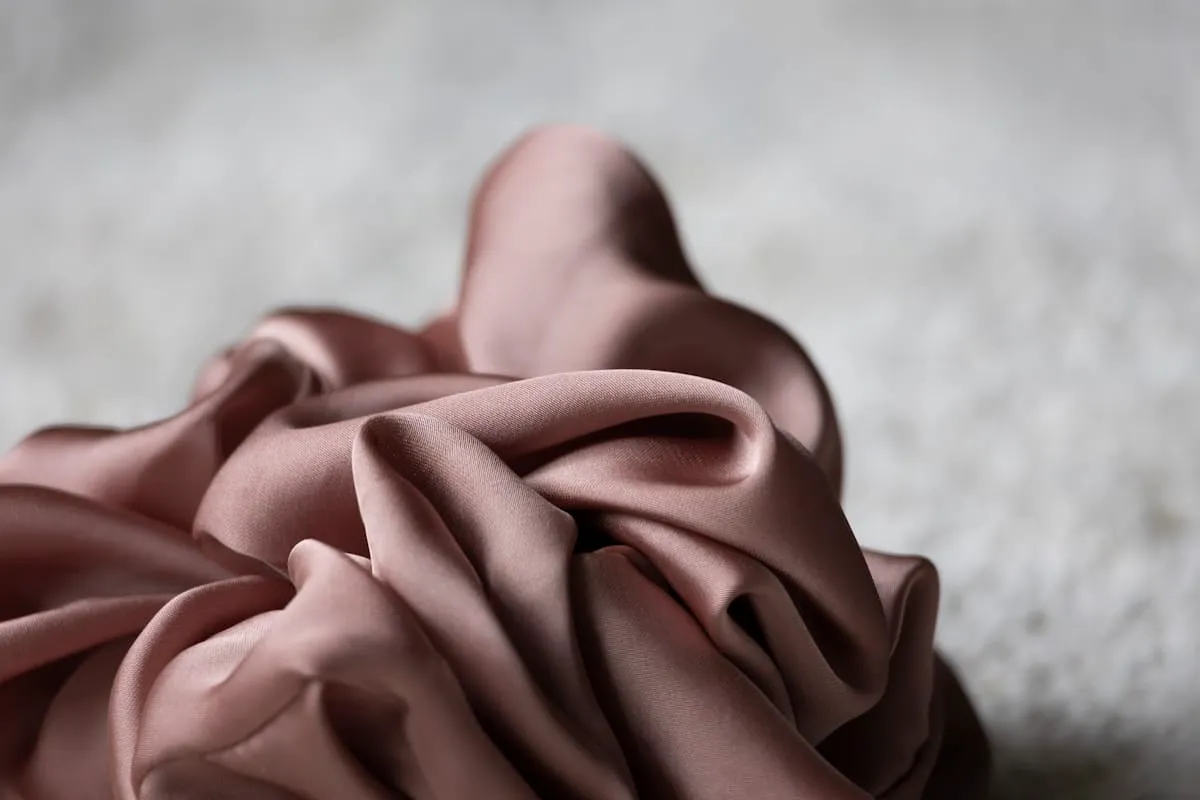 Taupe satin draped in a refined decorative arrangement