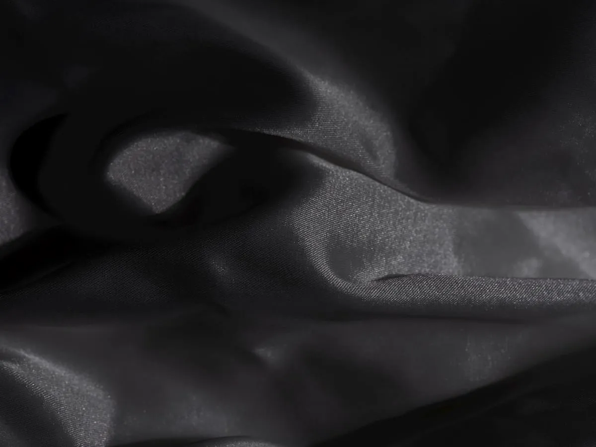Black satin textile with subtle highlights