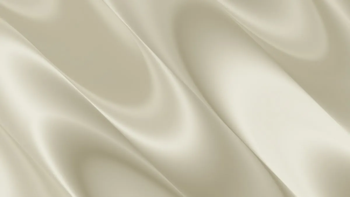 Cream satin fabric in soft luminous folds