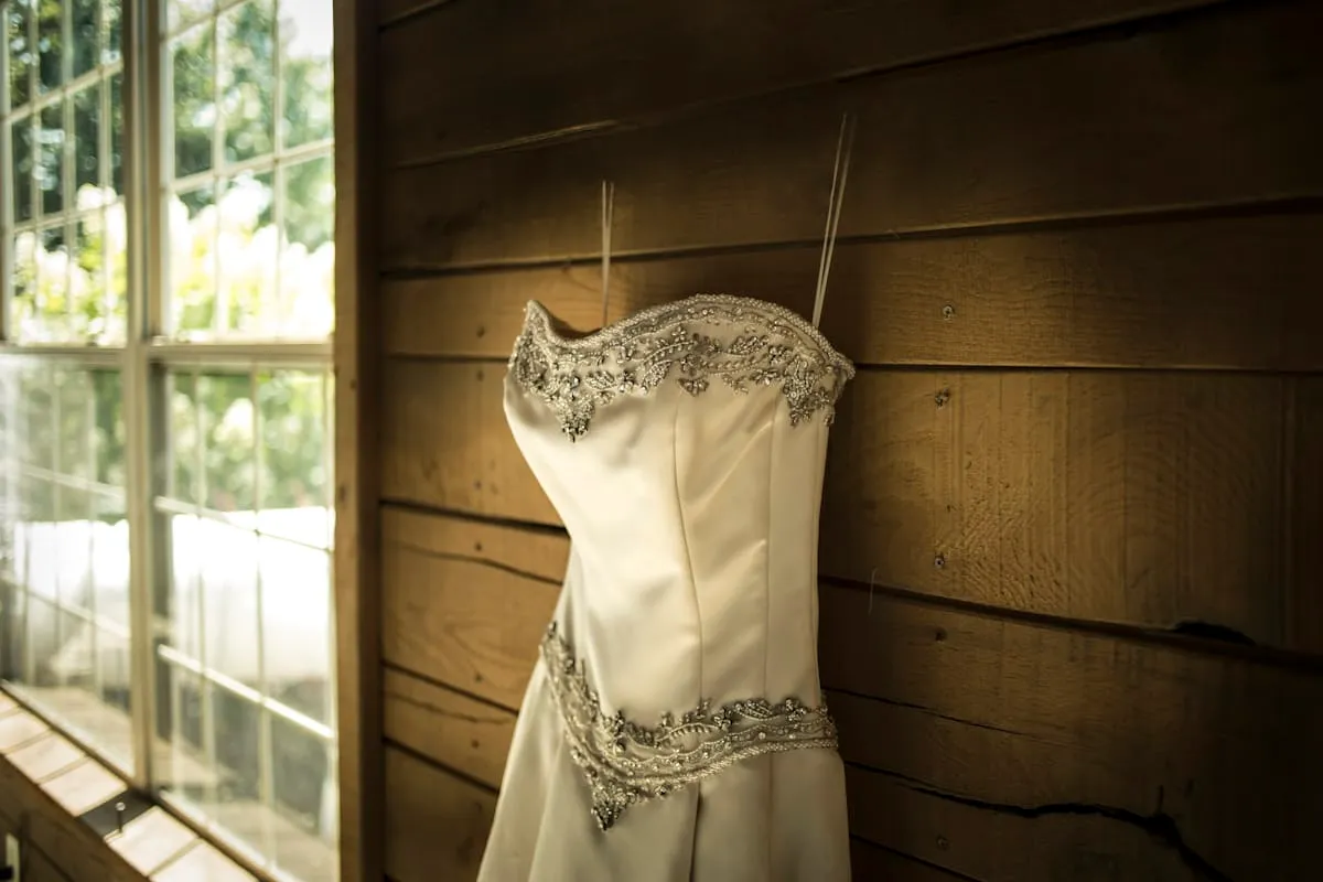 Ivory satin dress displayed in an atelier setting